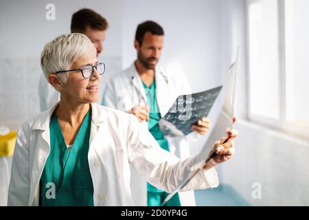 Doctors examining an x-ray report in hospital to make diagnosis Stock Photo