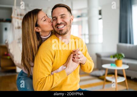 Beautiful couple in love is enjoying the company of each other at home. Stock Photo