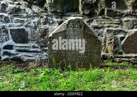 In Palmerstown, Dublin, Ireland, an old graveyard, beside an old church ruin, which dates back to 1200ad. This grave refers to a death in 1893. Stock Photo