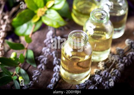 Lavender essential oil in a little bottles on wooden background ...