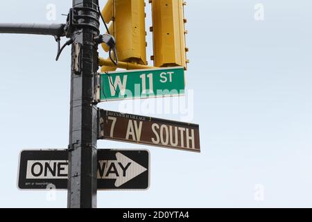 Street signs on the corner of 7th Ave South and West 11th Street in Greenwich Village, New York City; copy space on blue sky Stock Photo