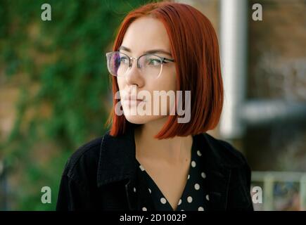 Portrait of beautiful redhead woman wearing glasses. Stock Photo