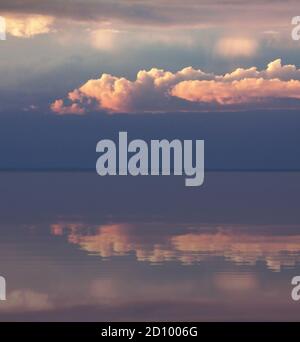 Late afternoon cloudscape reflected in water Stock Photo