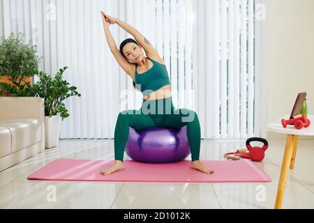 Woman doing side bends Stock Photo