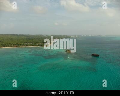 Vertical drone shot, aerial view of Rocky Cay beach, San Andres, Colombia. Crystal water that seems having sever colours. High view of the coast. Stock Photo
