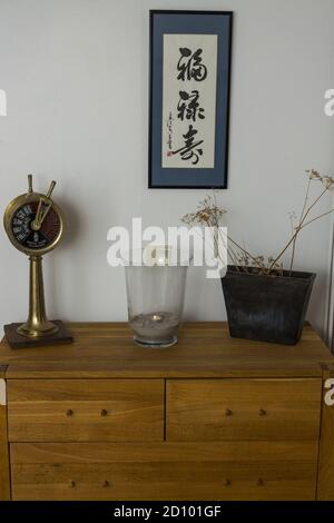 Close up view of old furniture with decorative elements on white wall background. Interior concept. Stock Photo