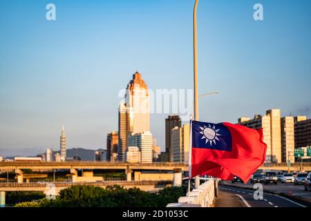 Taipei, Taiwan - Oct 4, 2020: Taiwan flag mockup fluttering in the wind. Aerial panorama over Downtown Taipei with Taipei 101 Skyscraper, capital city Stock Photo