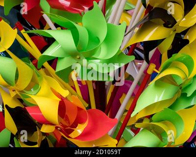 Rainbow colored pinwheels toys. Pinwheel background Stock Photo
