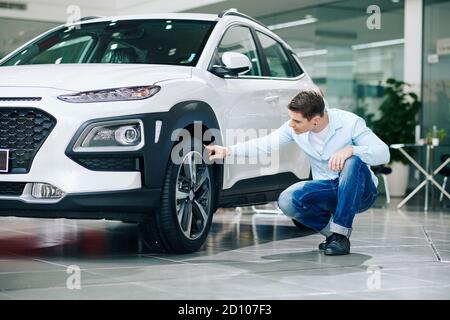 Man checking car tires Stock Photo