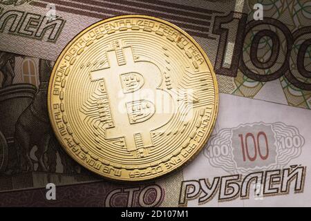 Bitcoin and Russian one hundred rubles close-up, top view Stock Photo