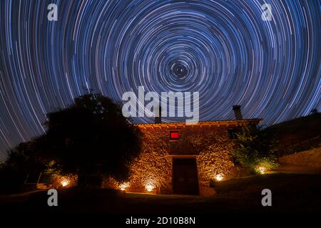 Star Trails over a Rural House Stock Photo