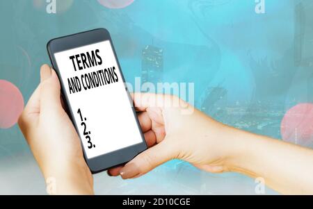 Handwriting text Terms And Conditions. Conceptual photo rules that apply to fulfilling a particular contract Modern gadgets with white display screen Stock Photo