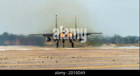 F-15E Strike Eagle, after burners lit, rolling down the runway at full power for take off Stock Photo