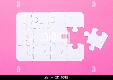 Last piece jigsaw White puzzle Concept success of business Pink background Top view - Image Stock Photo