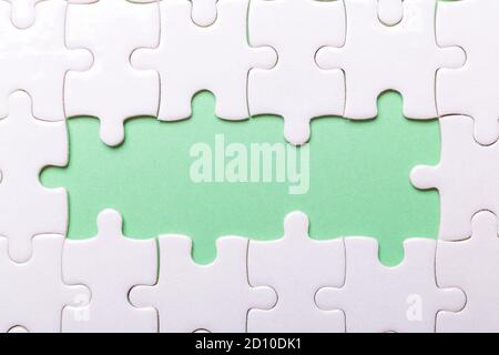 White puzzle background with pieces missing. Close-up. Copy space for text - Image Stock Photo