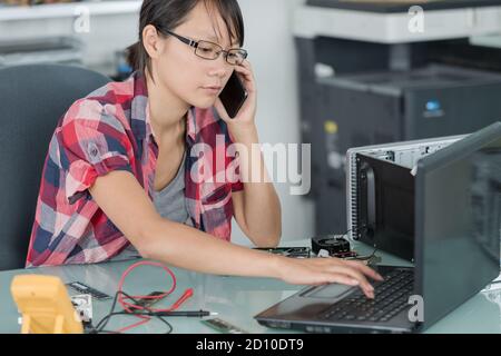 technician talking on phone in office Stock Photo