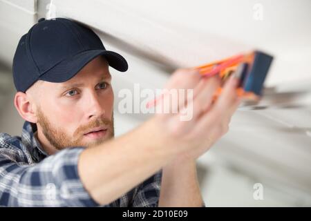 man taking measures with spirit level Stock Photo