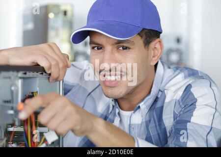 man working on computer assembly Stock Photo