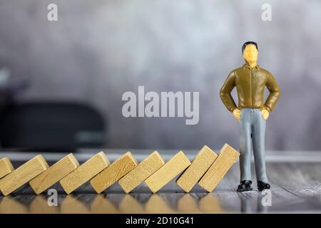 Businessman and  stops domino. Risk management concept. Stock Photo