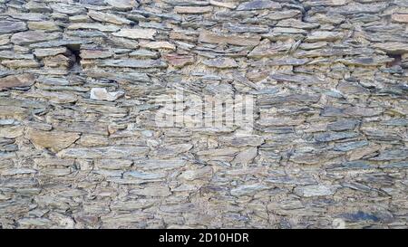 grey natural rough granite stone wall texture beautiful background. Stock Photo