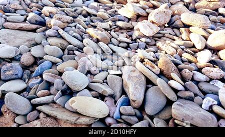 natural pebbles stone, grey gravel beach texture background. Stock Photo