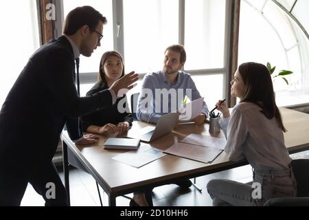 Skilled 30s confident leader in formal wear holding brainstorming meeting. Stock Photo