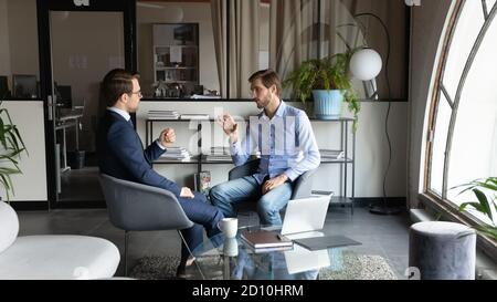 Two colleagues discussing project ideas in modern office. Stock Photo