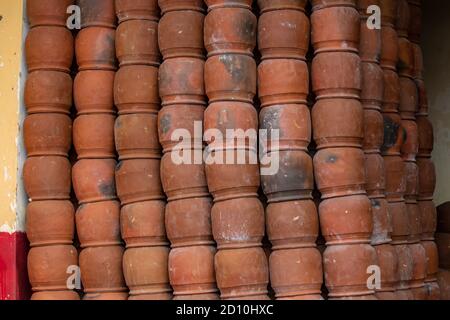 Many big brown caly pots stacked on top of each other in a tall rows, Bhuabneswar, India Stock Photo