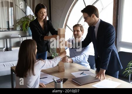 Happy young mixed race colleagues enjoying teambuilding activity. Stock Photo