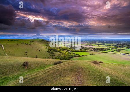 Scattered clouds over the village of Fulking village on the South Downs National Park from Devil's Dyke, Sussex, England Stock Photo