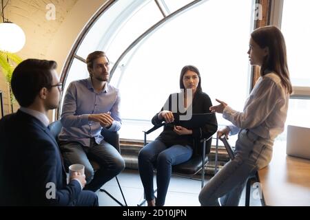 Concentrated young woman reporting on current issues. Stock Photo
