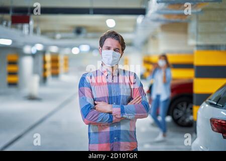 Adult man in protection mask in underground parking lot Stock Photo