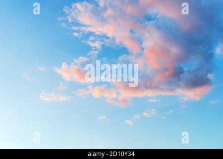 Vanilla sky. Azure sunset sky with light pink clouds. Tranquil skyscape just before the sundown. Pastel colored heaven for romantic mood background. Stock Photo