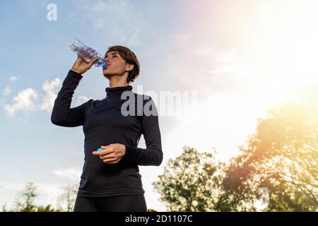 portrait of a girl who drinks water from a bottle. High quality photo Stock Photo