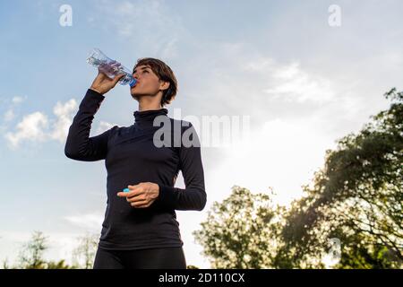 portrait of a girl who drinks water from a bottle. High quality photo Stock Photo