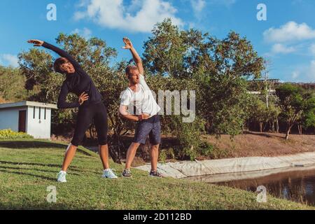 a guy with a girl doing a warm-up in the park. High quality photo Stock Photo
