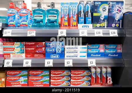 Toothpaste and toothbrushes in a supermarket shelf, Germany Stock Photo ...