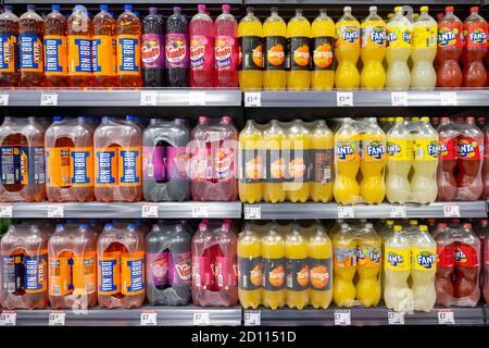 Bottles of 2 litre fizzy drinks on sale on a shelf in a supermarket in Cardiff, Wales, United Kingdom. Stock Photo