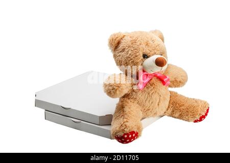A Teddy bear with two pizzas in boxes isolated on white background. Bear as a gift when buying two pizzas. Stock Photo