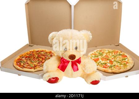 A Teddy bear with two pizzas in boxes isolated on white background. Bear as a gift when buying two pizzas. Stock Photo