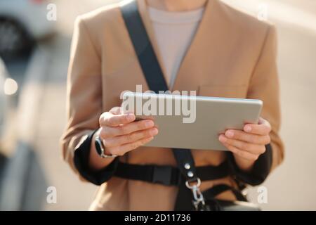 Hands of young elegant businesswoman with digital tablet watching online video Stock Photo