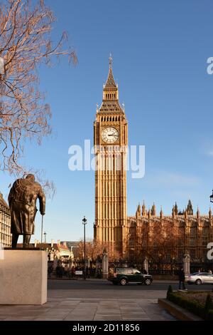 The Palace of Westminster, the Big Ben clock tower and a statue of Sir Winston Churchill, London, UK Stock Photo