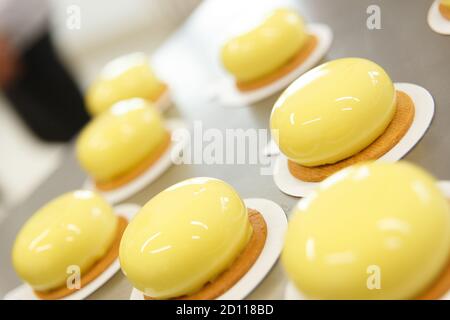 Decorates glazed pastries waits for a decorative elements. The process of cooking. Step by step. Tutorial. Stock Photo