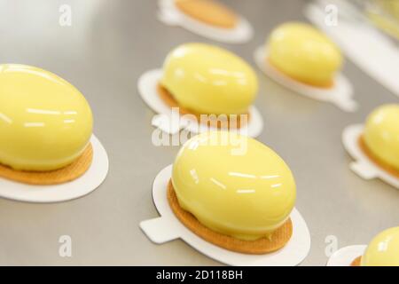 Decorates glazed pastries waits for a decorative elements. The process of cooking. Step by step. Tutorial. Stock Photo