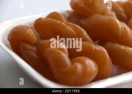 South African koeksisters in a polystyrene tray isolated on a white background Stock Photo