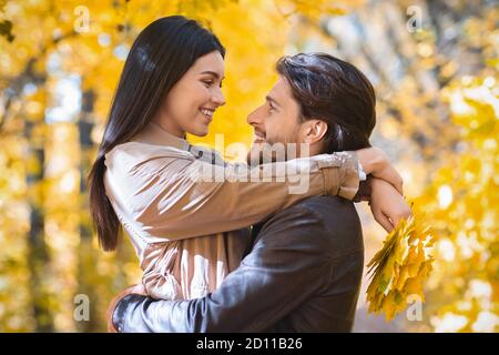 Portrait of embracing loving couple, enjoying time together at forest Stock Photo