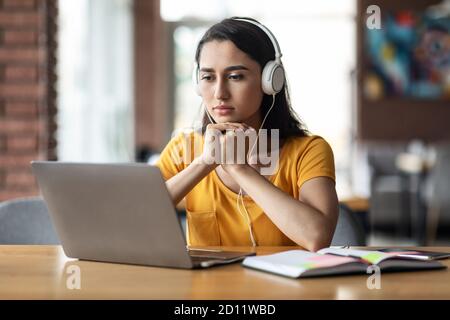 Concentrated young arab lady having educational course online Stock Photo