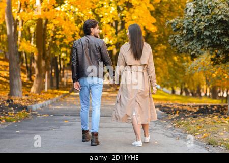 Lovers spending time together in autumn forest, walking by Stock Photo