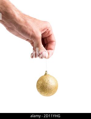 Man holding beautiful golden ball in hand, isolated on white Stock Photo
