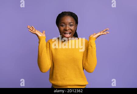 Happy Emotion. Joyful Black Woman In Yellow Sweater Exclaiming With Excitement Stock Photo